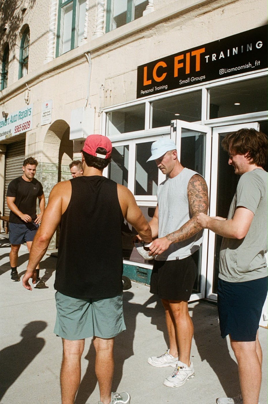 The crew gathered at the studio entrance under the LC FIT sign